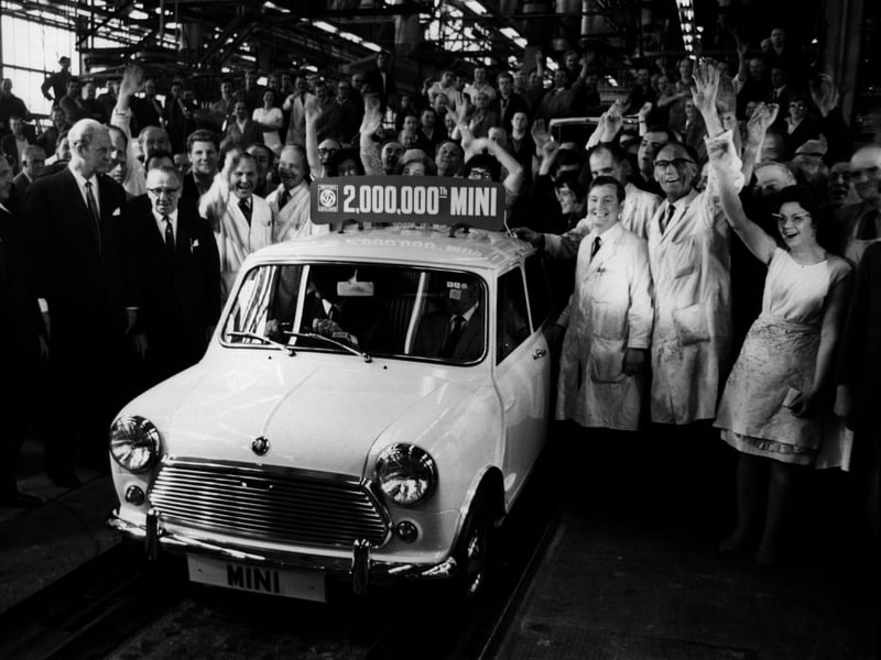 The Mini reaches a major milestone, as the 2 millionth car rolls off the production line at Longbridge, Birmingham, the plant of British Leyland's Austin Morris division, in June 1969. George Turnbull, managing director of the division, sits at the wheel, next to Alec Issigonis, designer of the Mini.