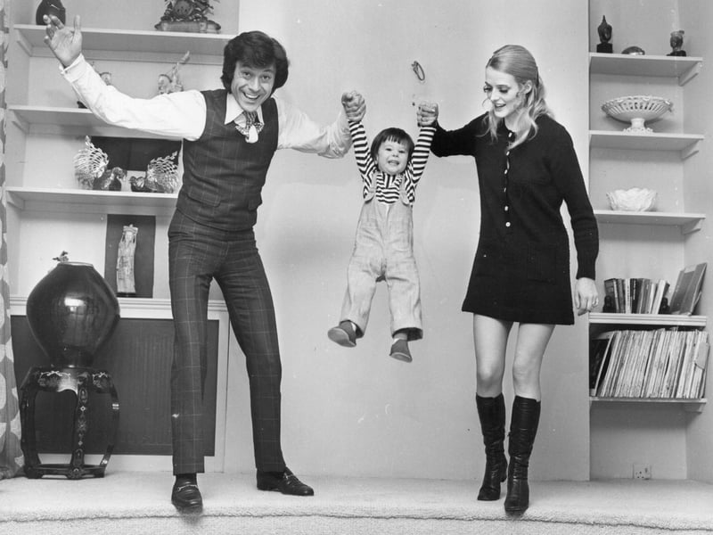 Dancer Lionel Blair and his wife Susan swing their son David between them in April 1970