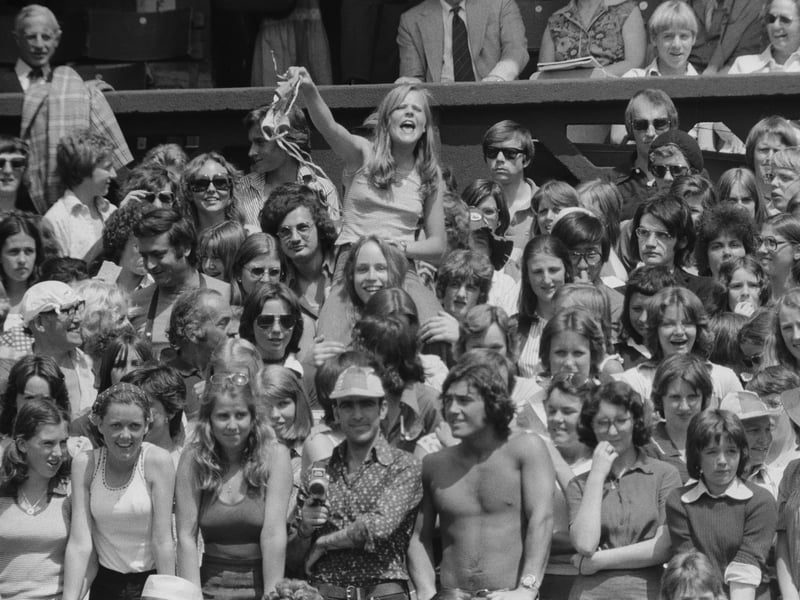 An excited fan waves her underwear at Swedish tennis player Bjorn Borg on Centre Court at Wimbledon in June 1975