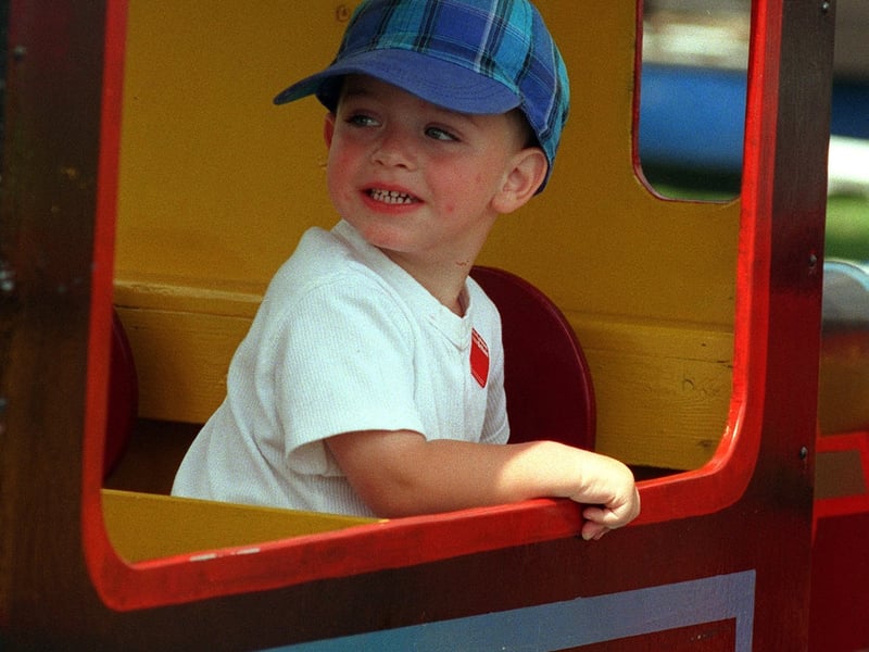 Andrew Keane takes the train on one of the fairground rides at Holbeck Gala in July 1999.