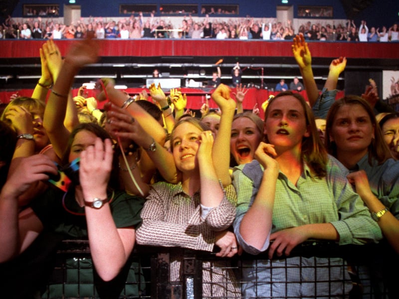 Fans watch Robbie Williams perform at the Town and Country Club, Leeds, in 1997