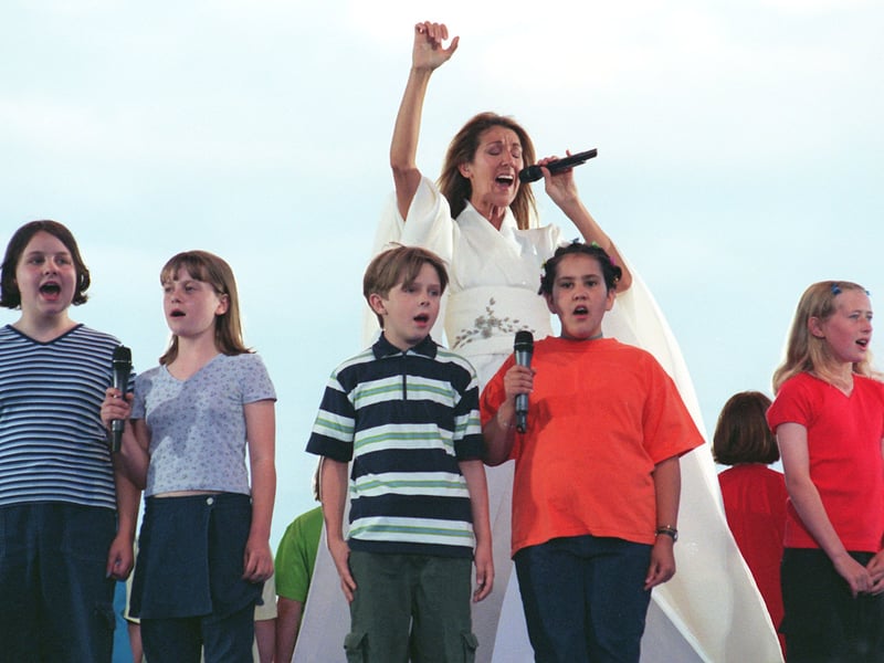 Celine Dion performing at Don Valley Stadium with Sheffield Children's Choir in July 1999
