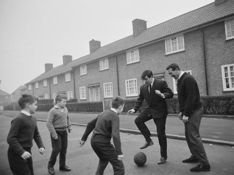 English soccer players Terry Venables and Ken Brown playing with local kids on Bonham Road in Dagenham, where they both grow up, in January 1965