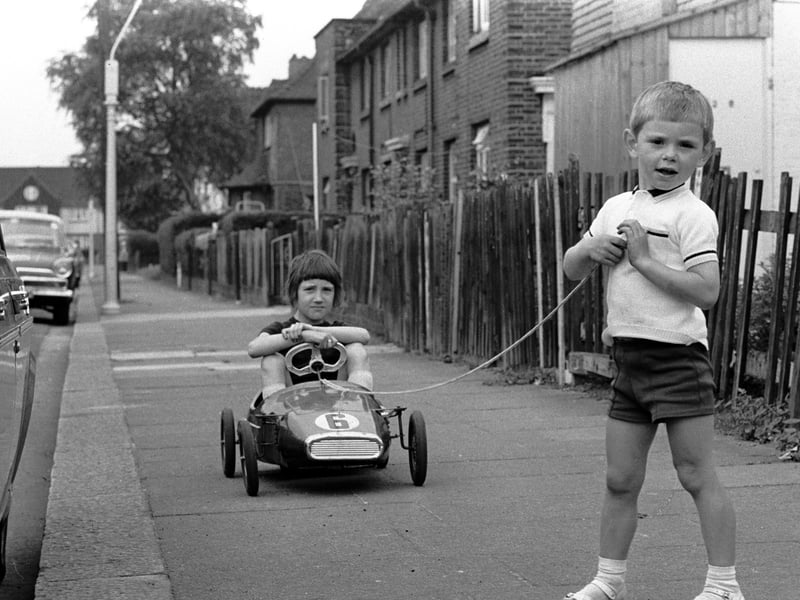 Boys playing with a go-kart in the 1960s
