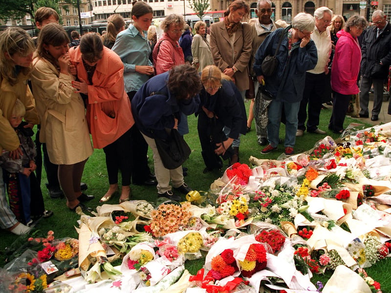 People read the messages on flowers left in tribute to Princess Diana outside Sheffield Cathedral after the memorial service in 1997
