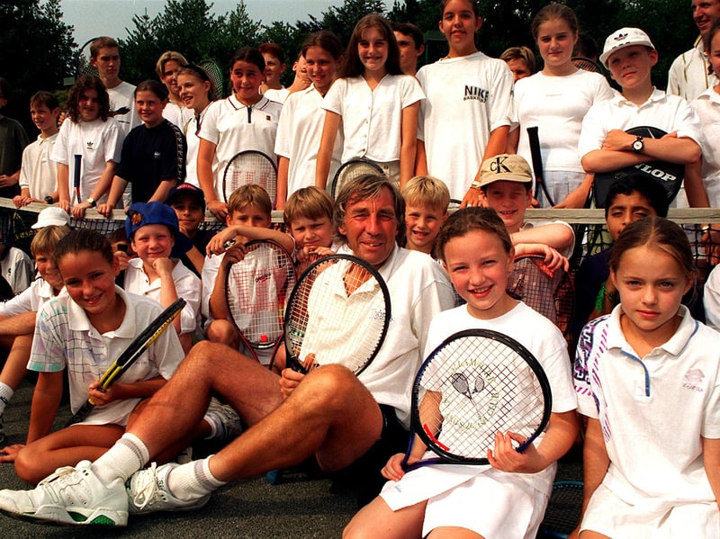 Tennis professional John Howarth with some of the children he has been coaching at the Hallam Tennis Club, Sheffield, in August 1997