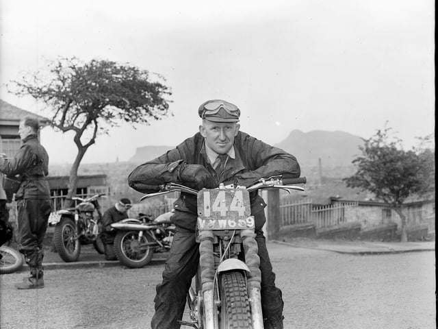 G.L. Jackson, the winner of the Scottish Six Days Motor Cycle Trial 1956, relaxing over his handlebars at Blackford Hill  in Edinburgh.