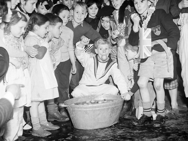 Boys dooking for apples at the Tweedie Memorial Boys Club Halloween party at the West Port in 1956.