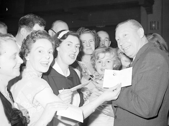 George Formby swamped by autograph hunters at the Press Ball in Edinburgh's Assembly Rooms in October 1956.