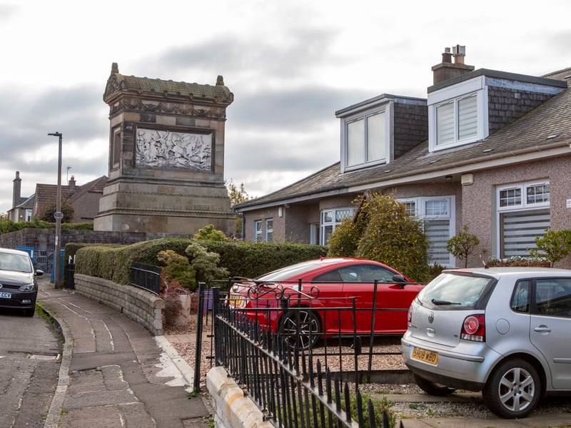 The mausoleum towers over the 1930s bungalows on the street