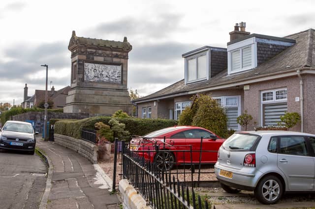 The mausoleum towers over the 1930s bungalows on the street
