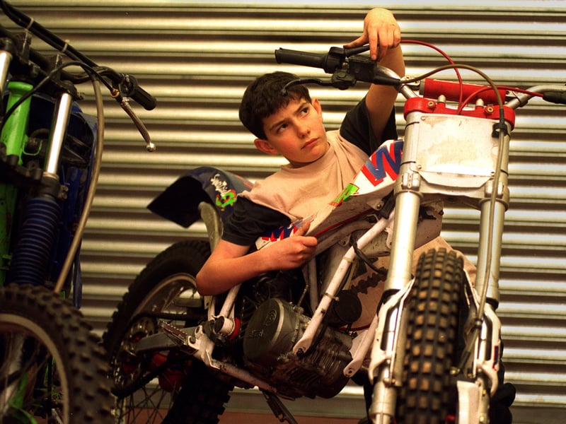 Callum Gibbs working on a trials motorcycle at Champ in December 1995.