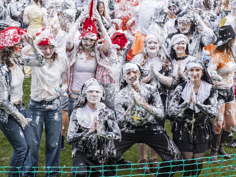 Students in fancy dress doused each other with shaving foam 
