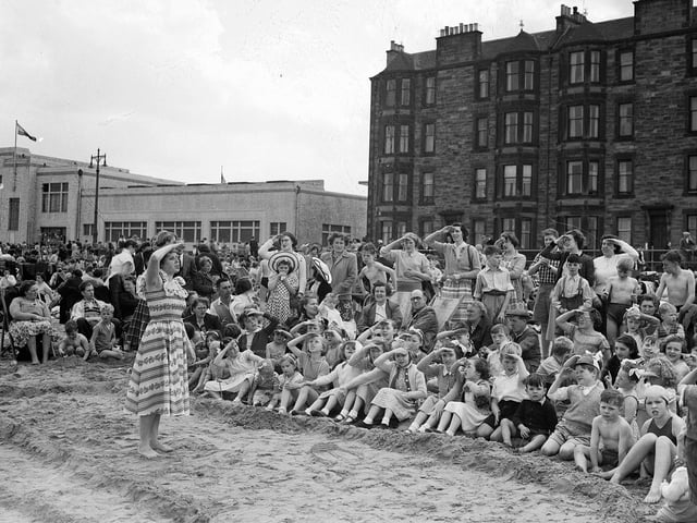 Children taking part in an 'action song' at the sea-side mission at Portobello Beach in July 1954.