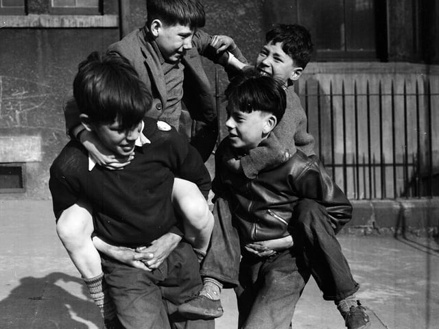 Children at play in Tron Square in April 1954 .