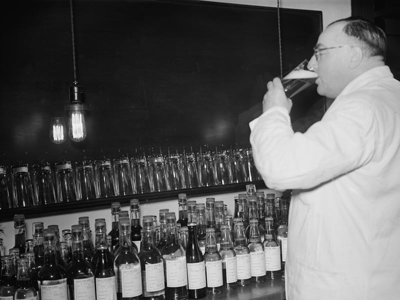 An employee taste-tasting beer at London's Whitbread brewery in November 1953