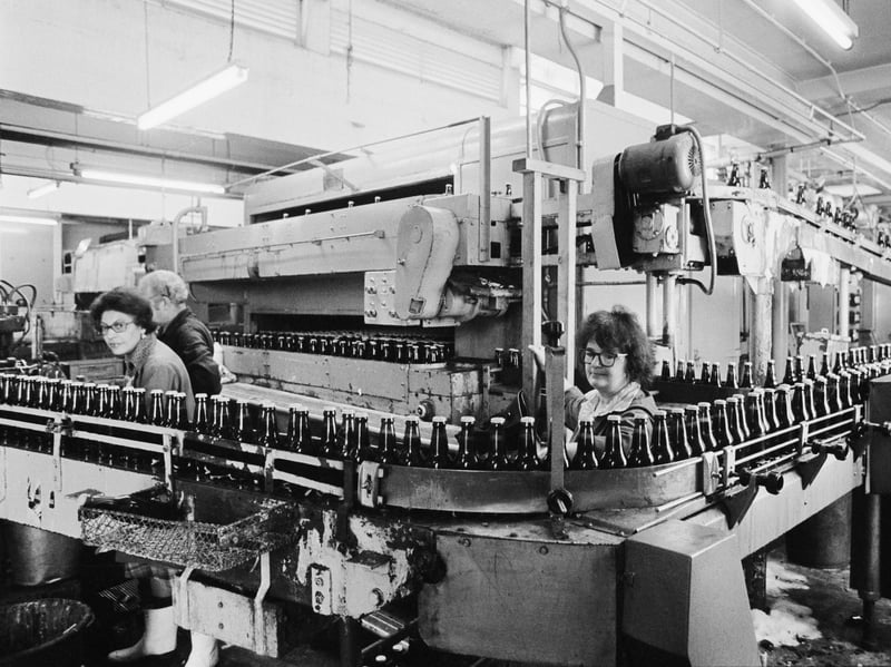 Workers in the bottling plant of Truman's Brewery, London, in August 1976