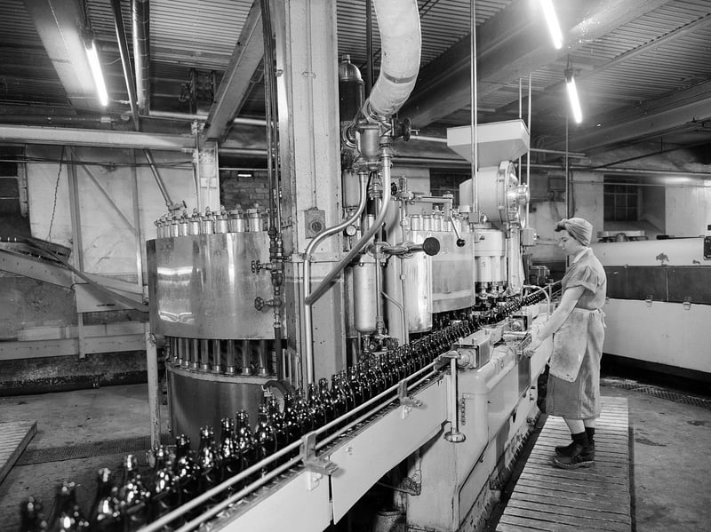 Bottling the beer at McEwan's Brewery, Fountainbridge, Edinburgh, in April 1960. William McEwan opened the Fountain Brewery in 1856. McEwan's later merged with Newcastle Breweries to form Scottish & Newcastle. The Fountain Brewery closed in 2005, with production moving to the Caledonian Brewery and John Smith's Brewery in Tadcaster. The McEwan's brand was sold to Heineken in 2008 and acquired by Marston's in 2017, with cans and bottles now brewed in Bedford, England.