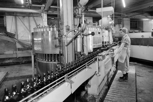Bottling the beer at McEwan's Brewery, Fountainbridge, Edinburgh, in April 1960. William McEwan opened the Fountain Brewery in 1856. McEwan's later merged with Newcastle Breweries to form Scottish & Newcastle. The Fountain Brewery closed in 2005, with production moving to the Caledonian Brewery and John Smith's Brewery in Tadcaster. The McEwan's brand was sold to Heineken in 2008 and acquired by Marston's in 2017, with cans and bottles now brewed in Bedford, England.