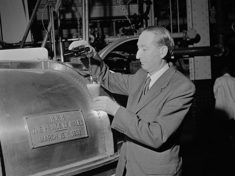 The Charrington Brewery head brewer, CF Mackay, pictured at the Anchor Brewery on Mile End Road, London, in November 1957. He is seen pouring a glass of bear from a bottle beside a cask bearing a plaque stating: "HRH The Prince of Wales - March 15th 1932." Charrington Brewery was founded in the early 1700s. Charrington merged with Bass in 1967 to become Bass Charrington, and in 2000, the company's brewing operations were bought by Interbrew. The Anchor Brewery ceased production in January 1975, but it remained the firm's head office.