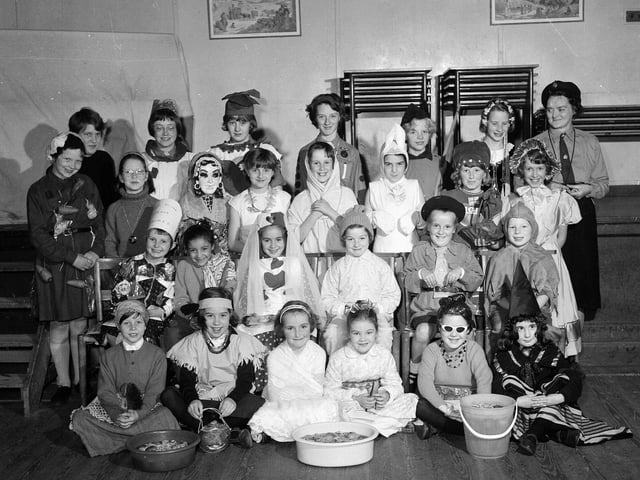 The Reid Memorial Church Brownie Pack enjoying a Halloween Party in 1964.