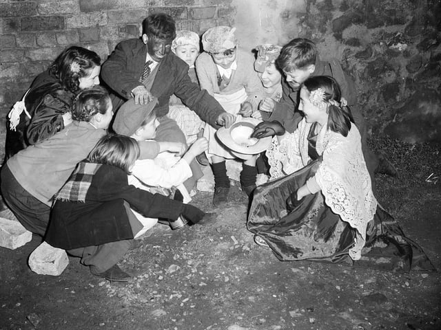 Edinburgh children count the money they made from guising in 1951.