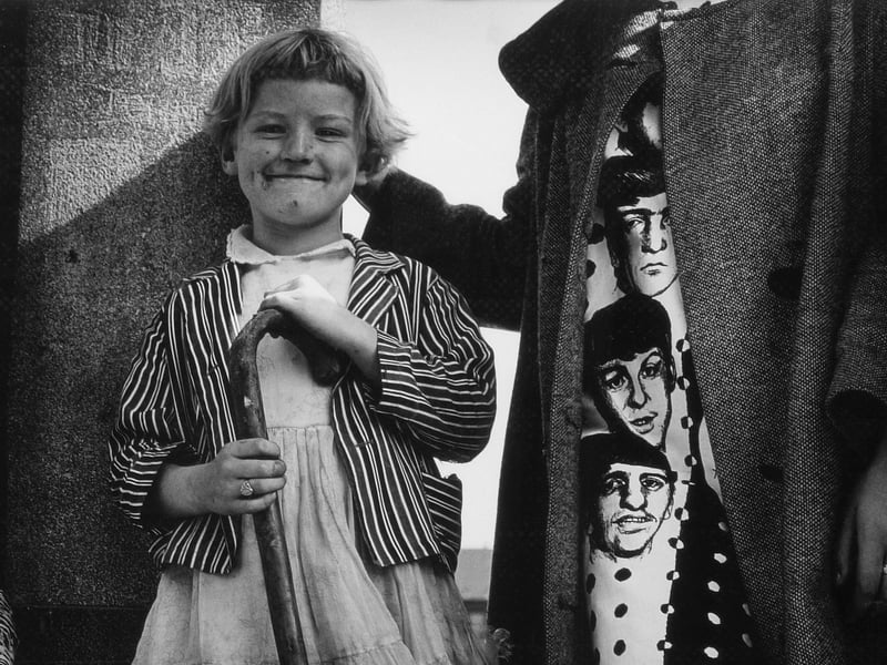Untitled photograph by Joseph McKenzie depicting girl holding walking stick and cut-off of girl wearing Beatle's dress