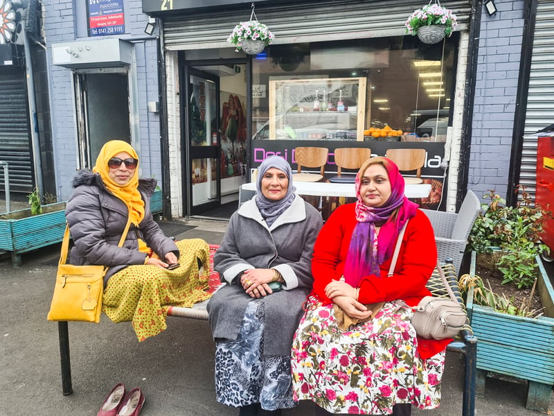 Digital colour photograph by Zubaidah Azad entitled 'Friends Getting Together' taken on Forth Street outside the Desi Dhaba café in 2023	