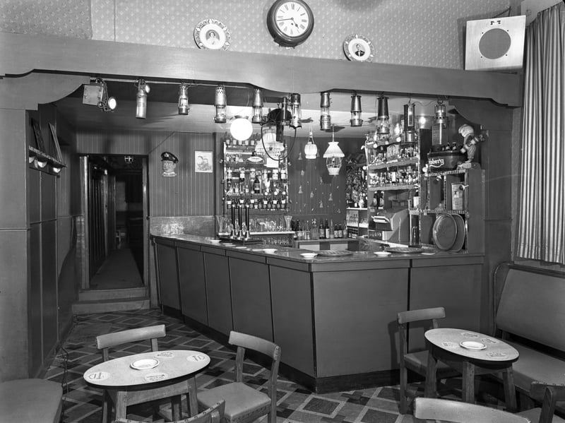 Inside the historic Ferryboat Inn, in Mexborough, South Yorkshire, in 1956. The photograph shows the bottom room, or 'tap' room at the pub, believed by some to date back to the 15th century, with the collection of miners' lamps which the owners (Mr Doug and Mrs Vi Watson) had on display at the time.