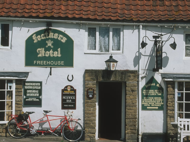 A tandem parked outside the Feathers freehouse pub and hotel in the rural village of Rievaulx, Helmsley, North Yorkshire, in June 1997