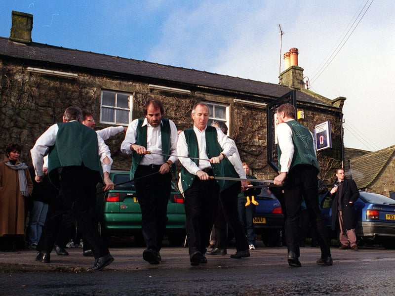 Members of the Highside Longsword based in Kirkby Malzeard take part in their 13th annual Christmas dance around the village of Grantley near Ripon in 1999. The six-strong team danced for around 10 minutes outside the Grantley Arms with regulars in the pub taking time out to watch the performance.