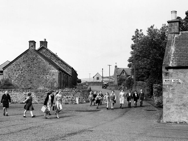 The 15 pupils from Crawfordjohn village, in Lanarkshire, on their way to school in September 1953.