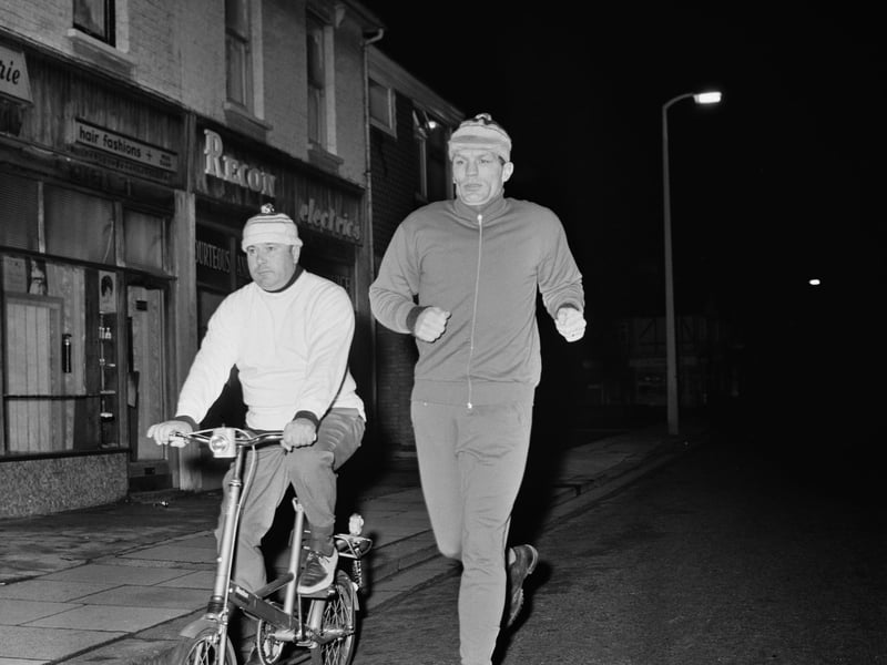 British heavyweight boxer Henry Cooper training at night for his upcoming fight with Cassius Clay (Muhammad Ali) in 1966, with the help of trainer and cornerman Danny Holland