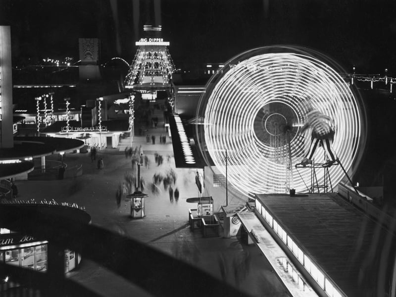 Illuminated rides at The Pleasure Beach in Blackpool, including a Ferris wheel and the Big Dipper, in September 1955