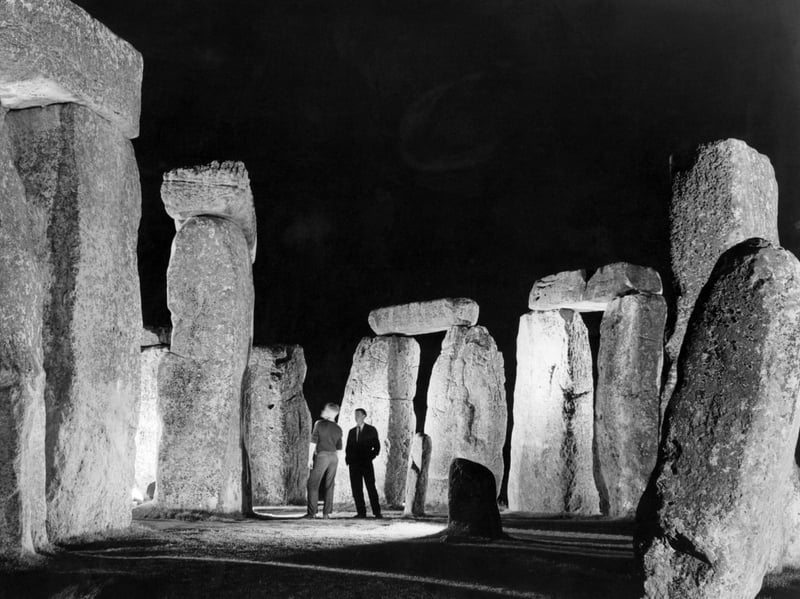 A couple enjoy the effect of spotlights on Stonehenge at night in around 1950