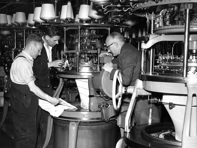 A mechanic makes an adjustment to a welding machine at the Lyle & Scott Knitwear factory in Hawick in 1950.