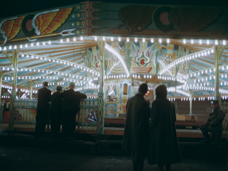 People watching the dodgem cars at night, at Blackpool Pleasure Beach, in around 1955