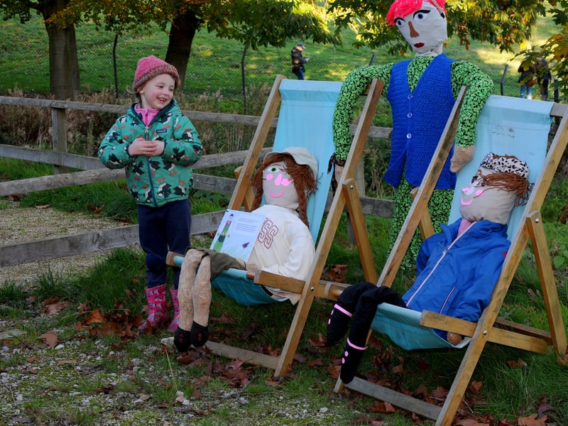 Four-year-old Bonnie Nield from Meanwood meets some of the scarecrows.