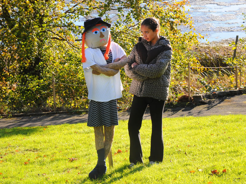 Laila Demonez, 11, from Moortown, has fun with a scarecrow.