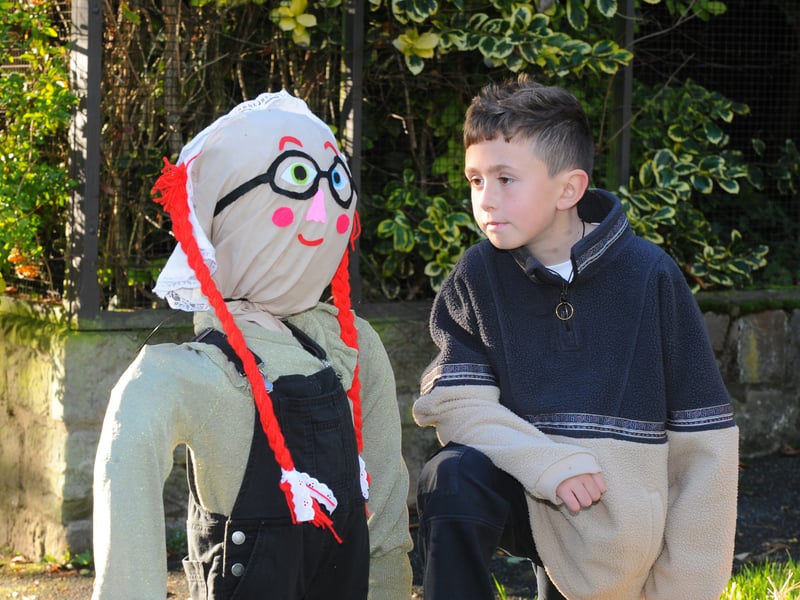 Eight-year-old Bobby Gascoine gets a close up of a scarecrow.