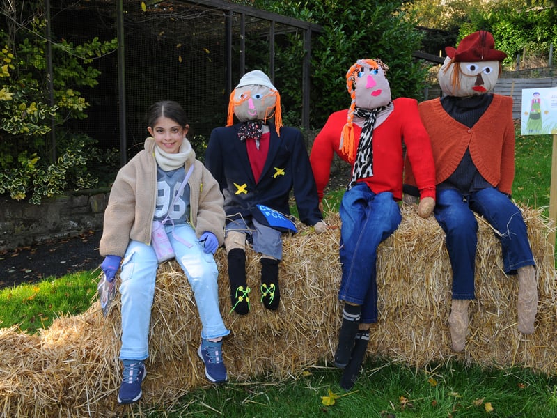 Eight-year-old Olivia Moura from KiIlingbeck relaxing with the scarecrows.