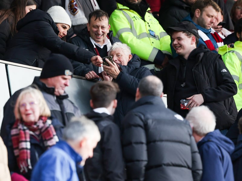 Fans take their opportunity to get a photo with Hearts investor Tony Bloom during the game against Celtic at Tynecastle.