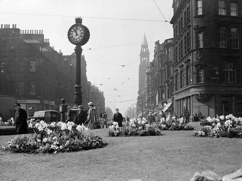 Spring flowers on the traffic island  next to the clock at the junction of Shandwick Place  and Princes Street in 1952. 