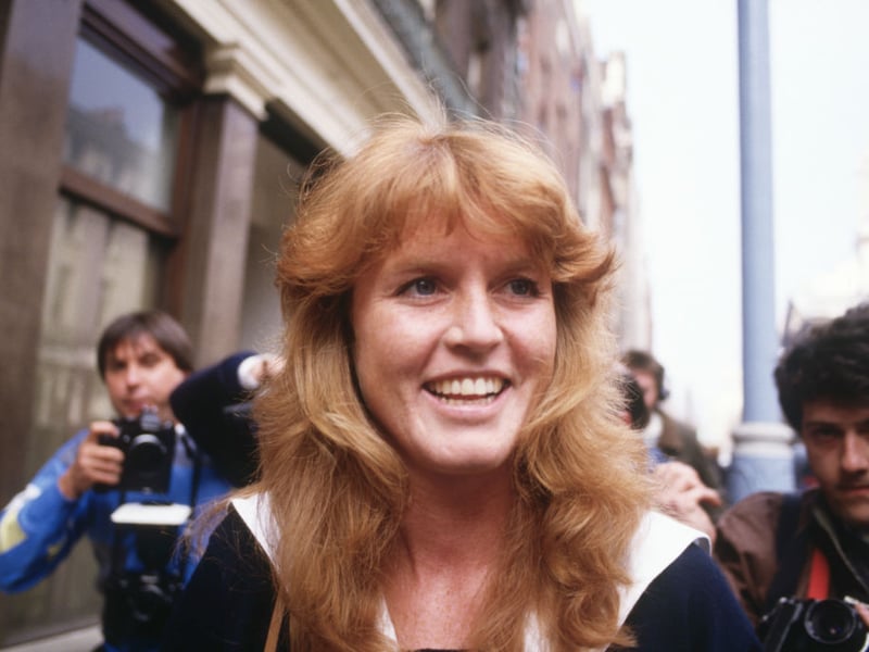   Sarah Ferguson (later Duchess of York) is surrounded by press photographers as she arrives for work in Mayfair, London on March 3, 1986. The announcement had just been made of her engagement to Prince Andrew. (