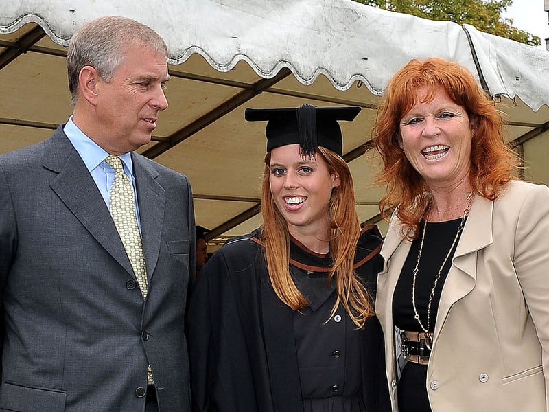 Princess Beatrice (C) poses for photograph with her parents, Britain's Prince Andrew, the Duke York (L) and Sarah Ferguson following her graduation ceremony at Goldsmiths College, in London, on September 9, 2011