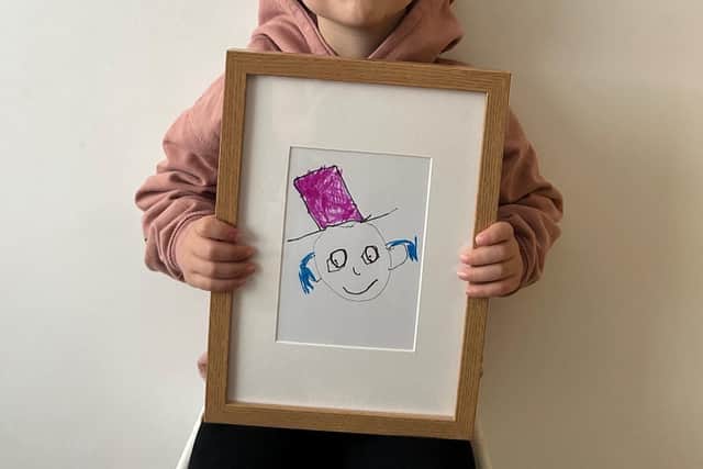 Jude in July 2023 when he started the Book Factory, with the logo he created. He made himself like the Willy Wonka of the book world with the big hat. The blue is his hearing aids.