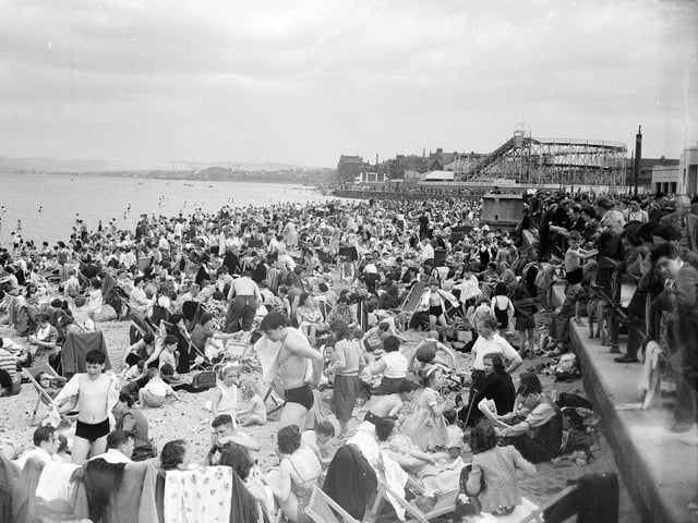 Crowds of holiday-makers on Portobello Beach in May 1952 with the rollercoaster and funfair in the background.