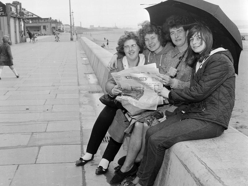 Visitors under their umbrella enjoying a wet summer day at Portobello in 1965