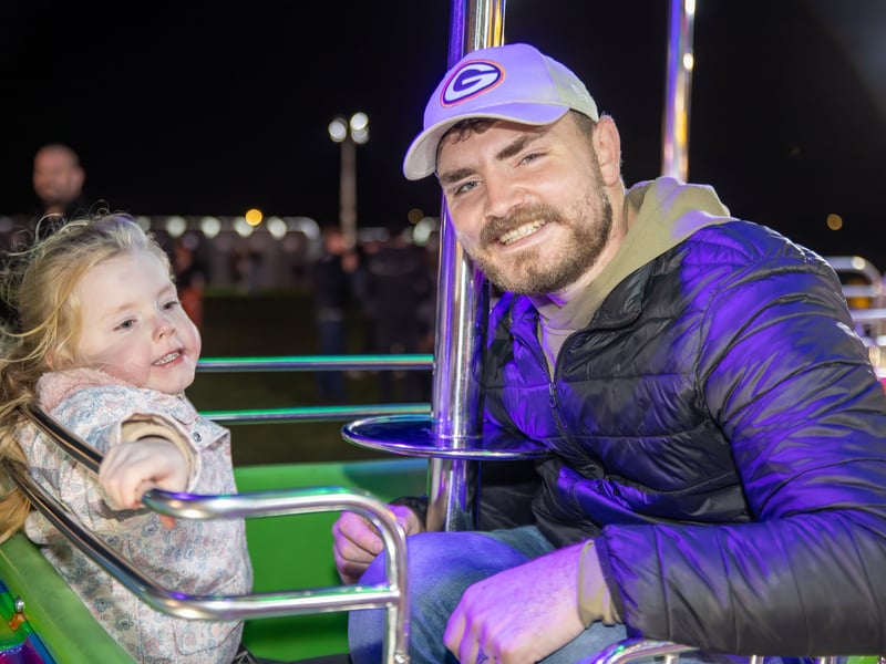 Penny, 5, enjoying HMS Sultan Bonfire Night 2025 with her dad.