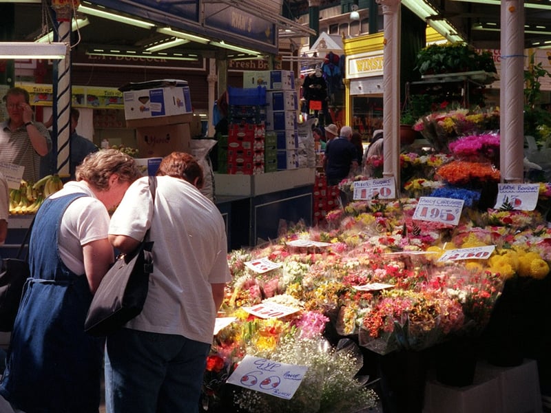 A couple check out flowers on a stall in June 1999.